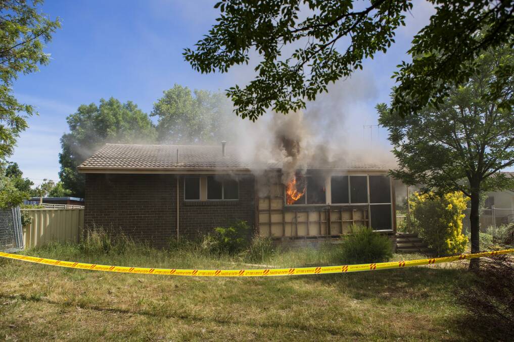 Hot property: Flames  billow from the windows of the Farrer house set alight for a training exercise. Photo: Jamila Toderas