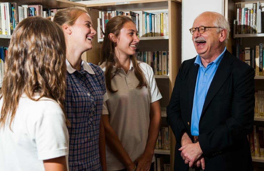 French writer Erik Orsenna speaks to year 10 students Meline Cretegny, of Griffith, Lea Texier, of Chapman, and Eline Dostal, of Jerrabomberra, all 15, about writing and literacy during a visit Telopea Park School/Lycee Franco Australien. Photo: Elesa Kurtz