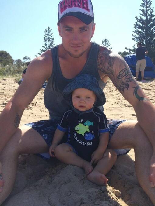 Hunter Reid with his dad Ryan. The little boy loved the beach. Photo: supplied