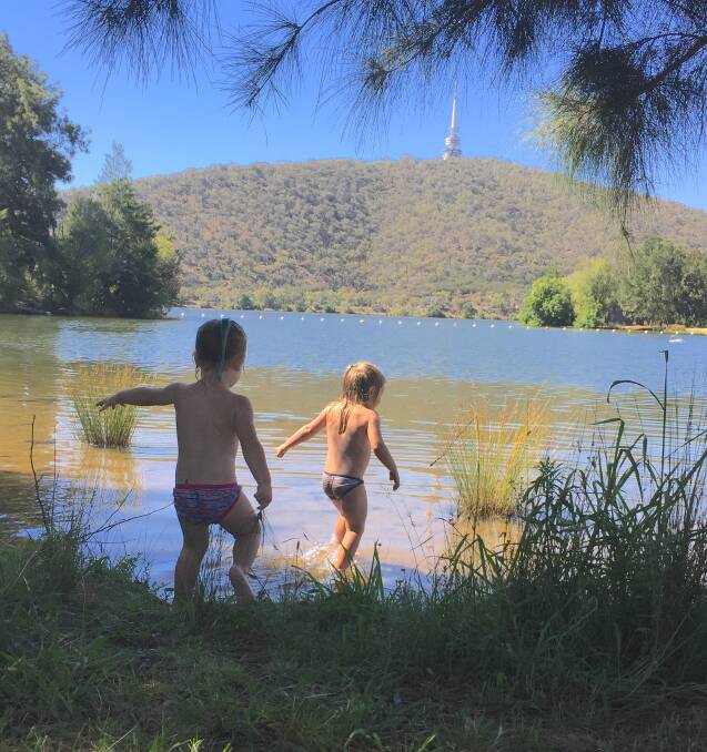 Heidi Young (5) and Emma Young (3) frolic in the shallows of Lake Burley Griffin at Black Mountain Peninsula. Photo: Judi Barton