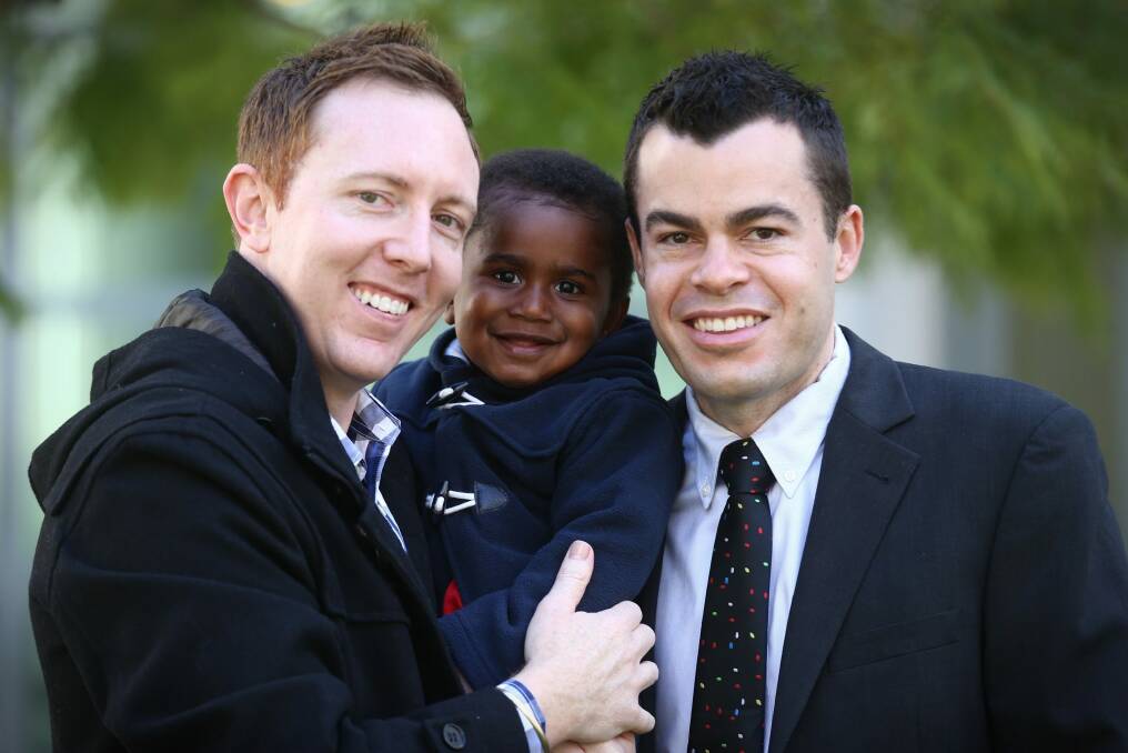 Jason Haines and David Momcilovic with their son, Oliver. Photo: Andrew Meares