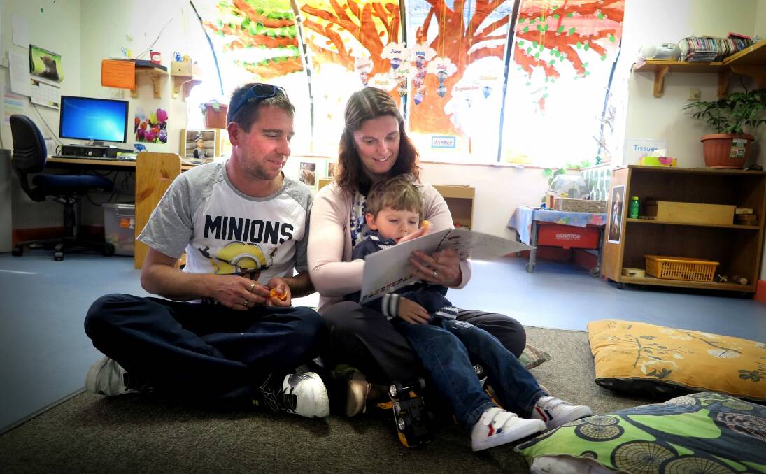 The Rohrlach family read the Mr Fluffy book. Rebecca and Matthew with son Trent, two. Photo: supplied