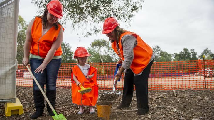 Adrielle Connors and daughter Amelia Connors, 3, and Minister Joy Burch at the first turn of the sod for Canberra College?s new CCCares facility at its Woden campus. Photo: Elesa Kurtz