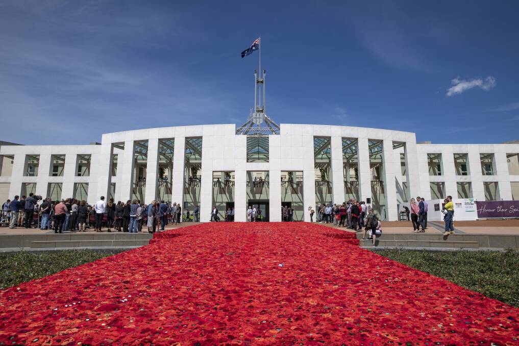 The approximately 270,000 poppies on the forecourt at Parliament House  have been handmade by men, women and children across Australia and overseas, as a tribute to Australians who have served in wars, conflicts and peace-keeping operations. Photo: Sitthixay Ditthavong