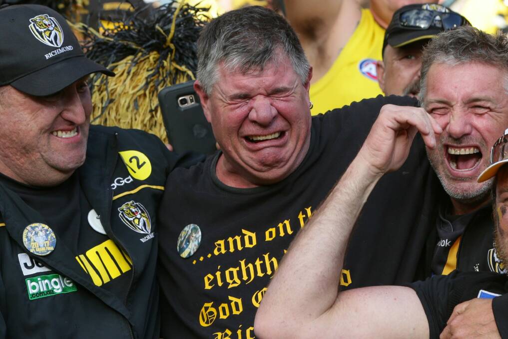 The tears flow: Richmond fans are overcome with emotion on Saturday. Photo: Jason South
