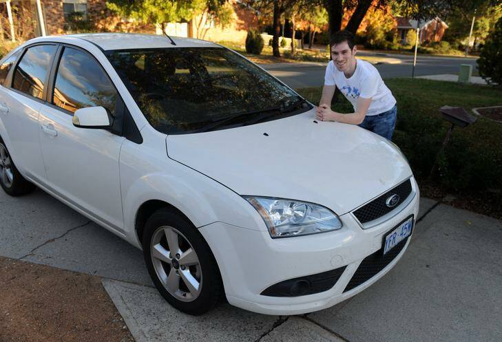 White car owner Blake Fenwick with his white Ford Focus, the most popular colour for cars in the ACT. Photo: Richard Briggs
