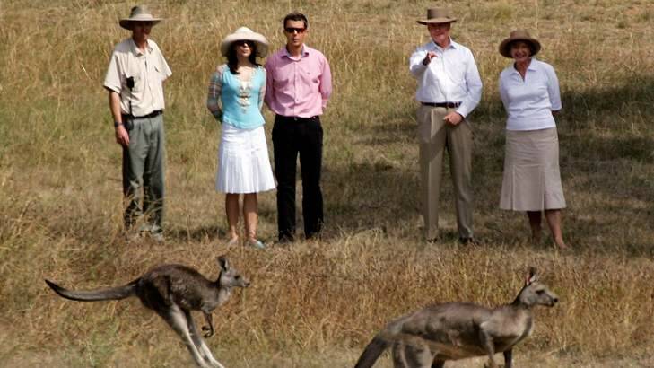 Denmark's Crown Prince Frederik (C) and his wife Princess Mary (2nd-L) are accompanied by Australia's then governor-general Michael Jeffery (2nd-R) and his wife, Marlena (R), as they look at kangaroos during a walk in the grounds of the Government House in Canberra March 9, 2005. Photo: David Gray