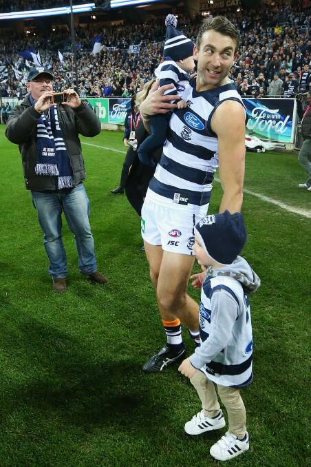 Corey Enright walks out with his kids for his 326th game for the Cats, a club record.  Photo: Michael Dodge