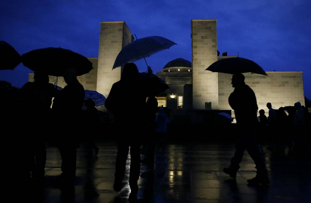 Canberrans braved the rain to attend the dawn service. Photo: Alex Ellinghausen