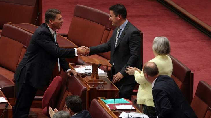 Senator Cory Bernardi congratulates Senator Zed Seselja after he delivered his maiden speech in the Senate. Photo: Alex Ellinghausen
