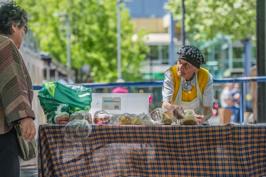 With sweet buns and doughnuts donated from the bakery, Stasia Dabrowski serves up lunch in Garema Place.  Photo: Karleen Minney