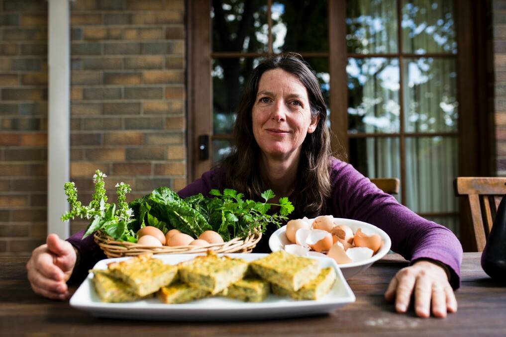 Emma Kain with her frittata, herbs and eggs. Photo: Jamila Toderas