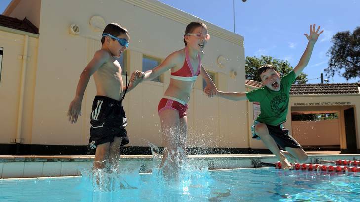 Manuka Pool opened its doors for the official swimming season. Making the most of the warm day in the water are L to R Freddy Falter 7 of Kingston, Fransje DeGraeff 10 of Aranda and her 8 year old brother Reimer. Photo: Graham Tidy