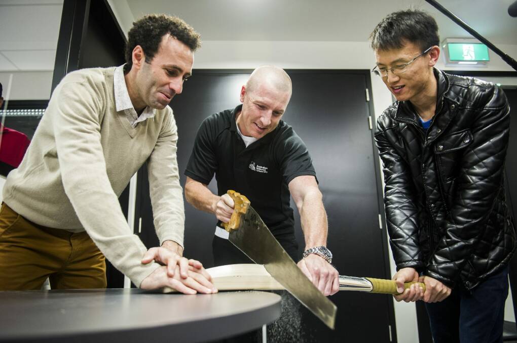 Australian wicketkeeper Brad Haddin meets scientists from the ANU, Dr Mohammad Saadatfar (left) and Jin Tao, who are doing technological research into cricket bats. Photo: Rohan Thomson