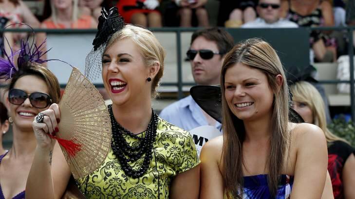 Tatum Brown of Kaleen and Kayla Sturgess of  MacGregor fan themselves as they check out the Classic Mens Racewear of Fashions on the Field  at Thoroughbred Park on Sunday. Photo: Jeffrey Chan