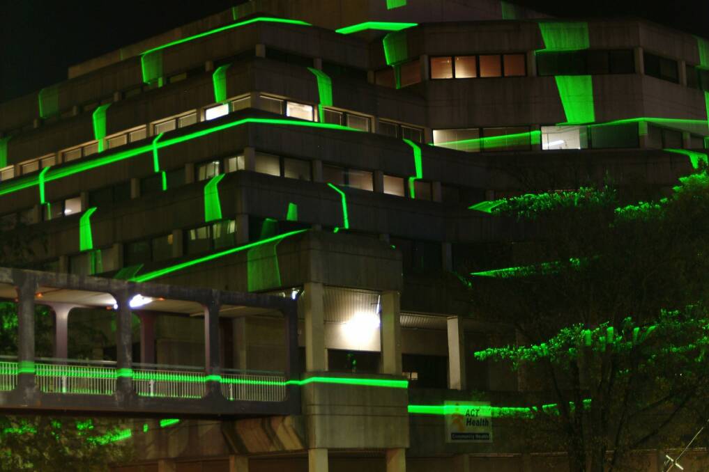 Public artwork LaserWrap, by artists Geoffrey Drake-Brockman and Richie Kuhaupt, when it was first installed in 2004 to project green laser light onto the ACT Health building in Civic.