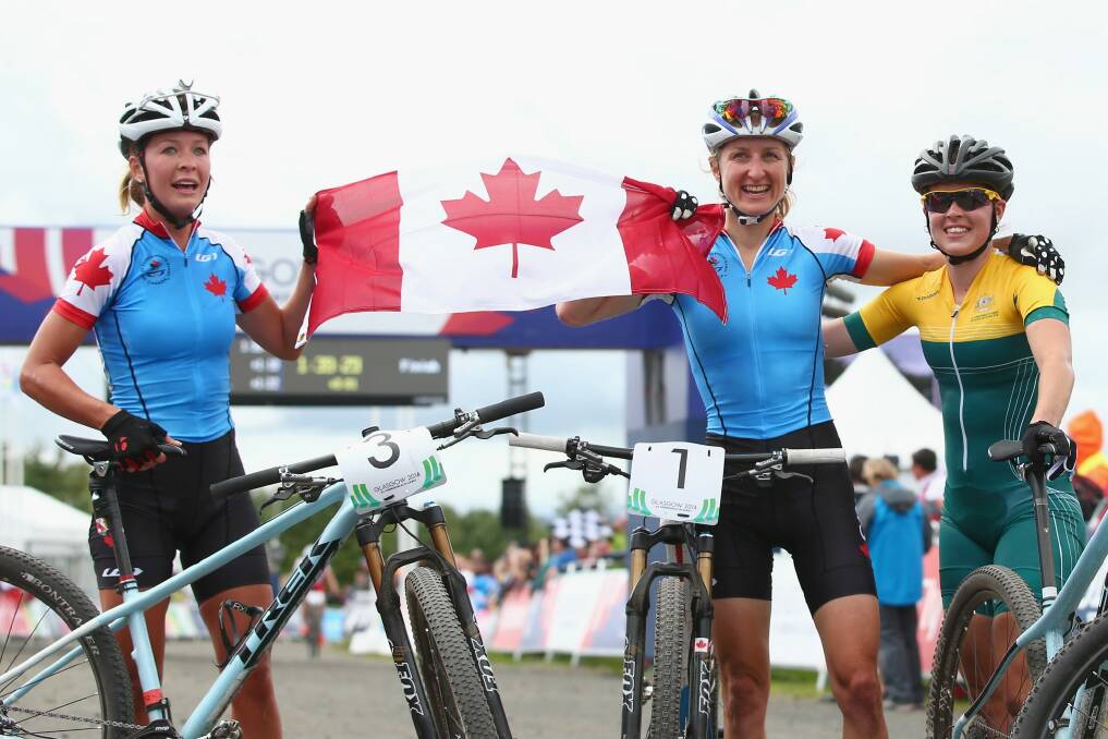 Silver medalist Emily Batty of Canada, gold medalist Catharine Pendrel of Canada and bronze medalist Rebecca Henderson of Australia pose as they celebrate after the Women's Cross-country Mountain Biking at Cathkin Braes Mountain Bike Trails. Photo: Getty Images