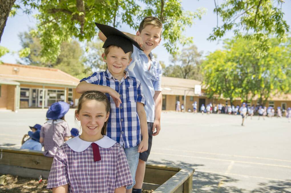 After graduating from The Shepherd Centre in Rivett where he has been receiving early intervention treatment to speak and listen more easily, Nate Korbl, five, will be joining his siblings Asha, 11, and Ryan, eight, at St John the Apostle Primary School in Florey. Photo: Jay Cronan