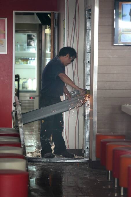 Workers repair damage to McDonald's Braddon restaurant following explosion.  Photo: Jeffrey Chan