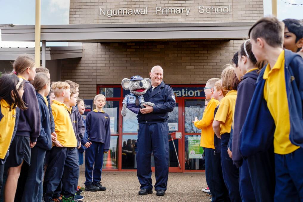 In their final appearance together on Tuesday, Constable Kenny Koala greets students at Ngunnawal Primary School with Stewart Waters.  Photo: Sitthixay Ditthavong