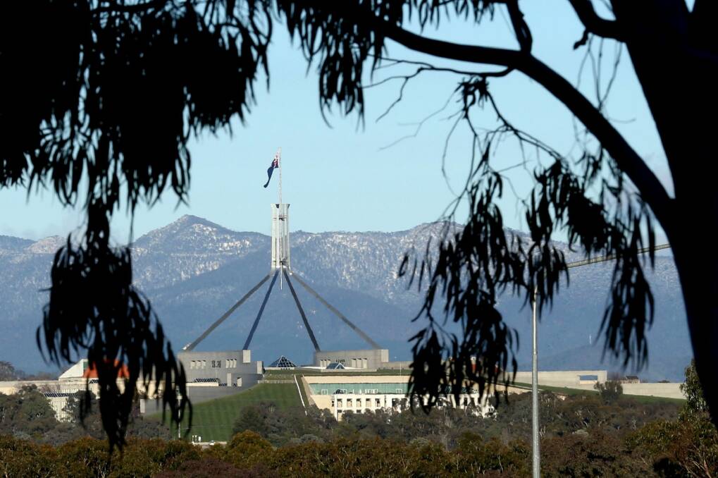 Snow settled on the Brindabellas behind Parliament House in August.  Photo: Andrew Meares