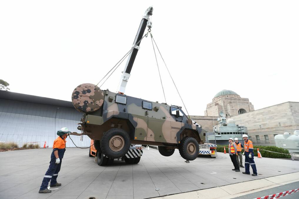 An Australian Army Bushmaster Protected Mobility Vehicle which served in Iraq and Afghanistan before being damaged in an engine fire in 2010, is installed as a permanent display outside the Australian War Memorial in Canberra.  Photo: Alex Ellinghausen