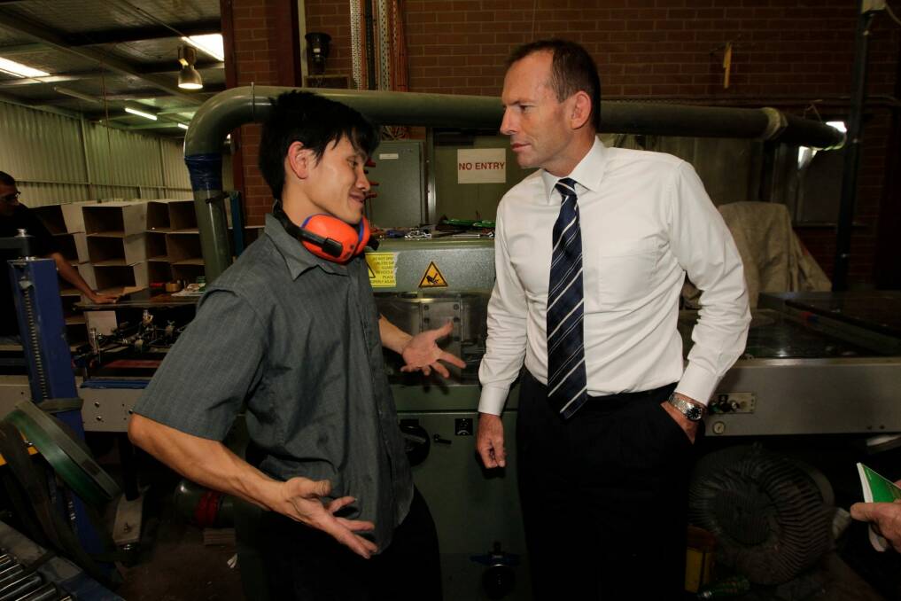  Then opposition leader Tony Abbott meeting Tuang Dong when he toured  Paragon Printing in 2011.  Photo: Andrew Meares
