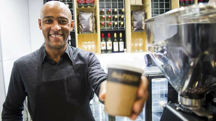 CAFFEINE HIT: George Gregan serves up a coffee at his new Canberra cafe at the Australian Institute of Sport on Thursday. Photo: Rohan Thomson