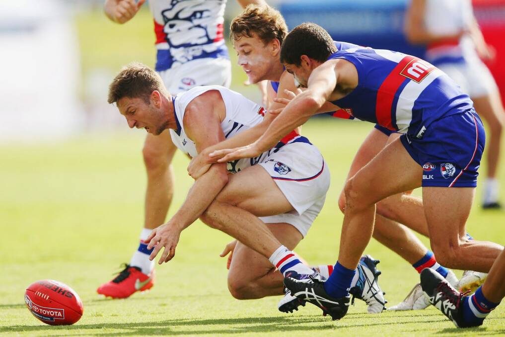 Matthew Boyd (left) competes for the ball against Mitch Wallis and Tom Liberatore (right) during the Western Bulldogs intra-club match at Whitten Oval on Saturday. Photo: Getty Images