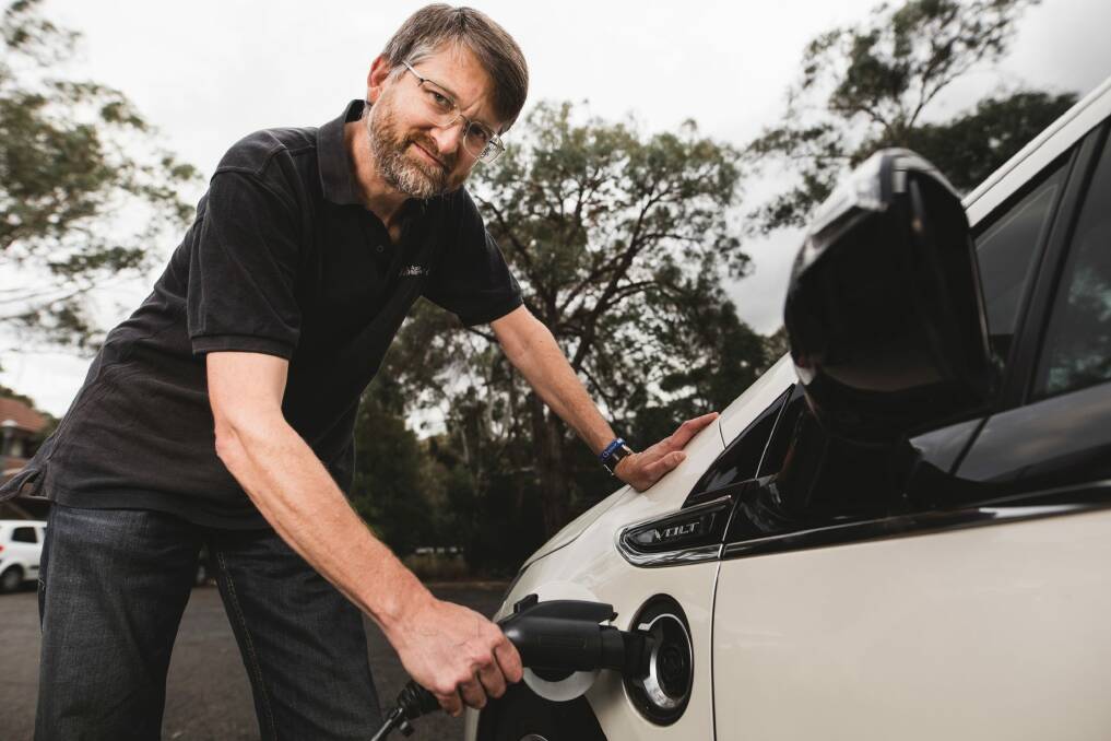 Peter Campbell charging his electric Holden Volt. Photo: Jamila Toderas