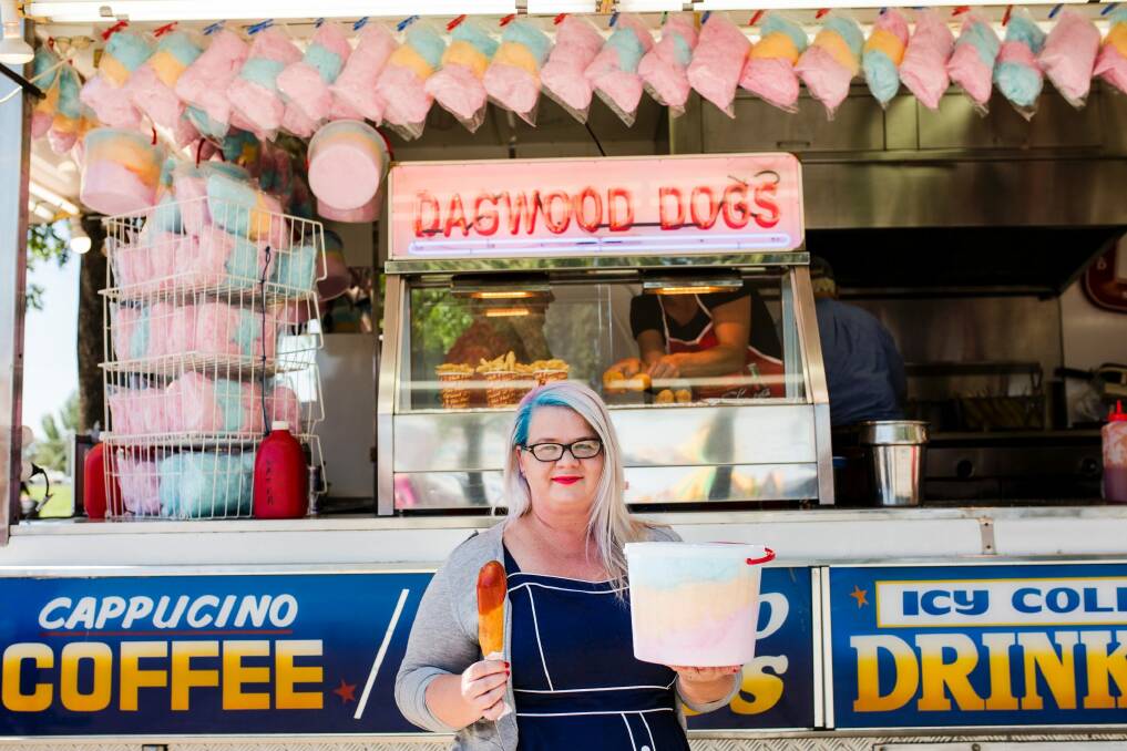 It's not a show experience without a Dagwood Dog - reporter Bree Winchester with her $8 dog and $10 bucket of fairy floss. Photo: Jamila Toderas