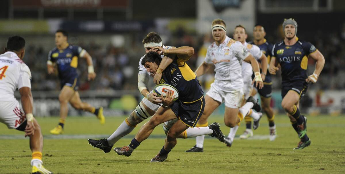 Glimmer in attack: Brumbies half Tomas Cubelli is tackled after making a break.