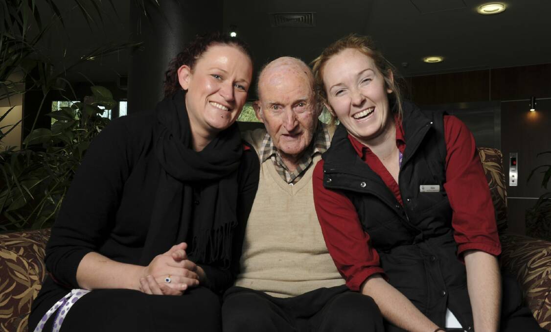 Goodwin Village, Ainslie, resident Ken Hardy flanked by activities officer Kylie Hannigan, and activities co-ordinator Abbie Dawson. Photo: Graham Tidy
