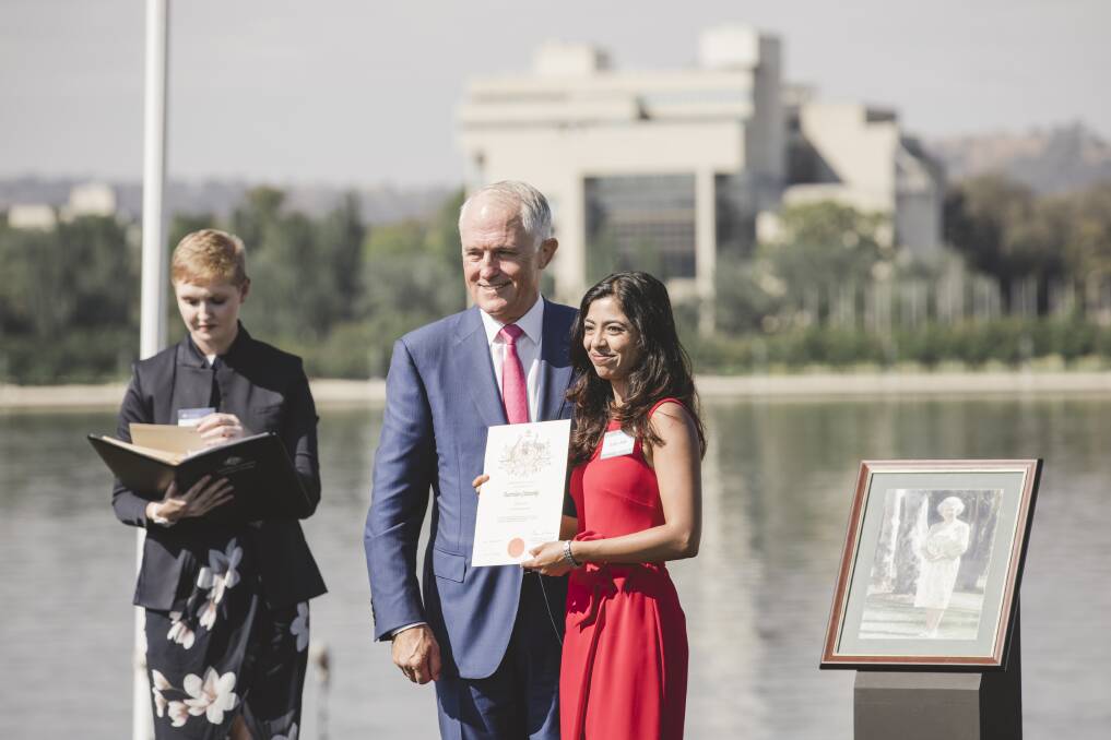 Former Prime Minister Malcolm Turnbull presents Daisy Jose with her Australian Citizenship. Photo: Jamila Toderas