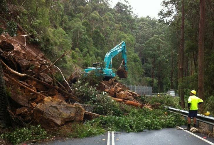 The landslide left dirt, rocks and trees blocking the highway. Photo: Supplied