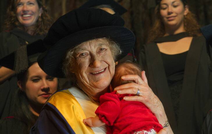 Rhodanthe Lipsett, 90, grained an honorary doctorate for services to midwifery and used her skills to calm fellow graduate Tess Farrell's six-week-old daughter Jade at the graduate class. Photo: Gary Schafer