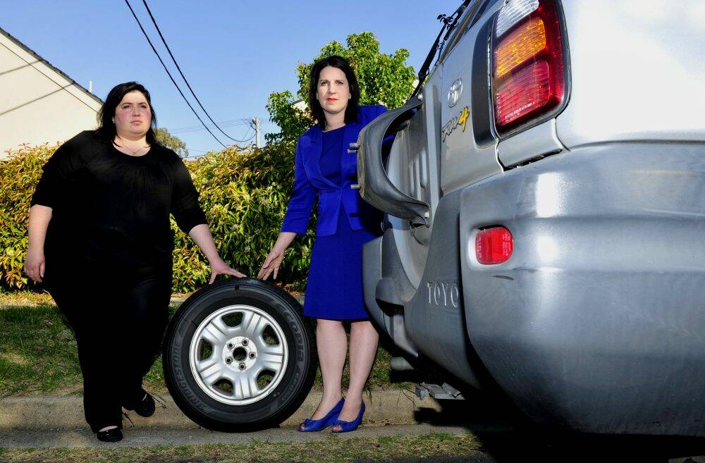 Liberal MLA Giulia Jones with her sister Lucia MacFarlane, left, who has had her tyres slashed for the second time by the notorious "Narrabundah slasher". Photo: Melissa Adams