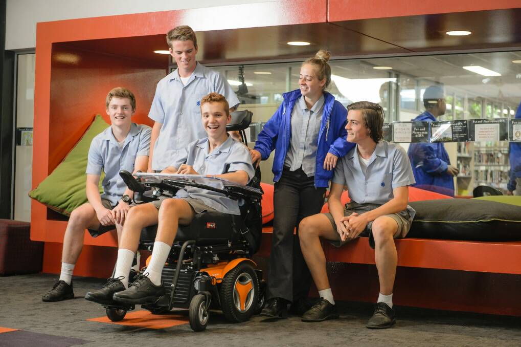 St Francis Xavier College students Charlie Mellick, Joseph Bishop, Marley Thomas, and Benjamin Mitchell have been great support for Elijah Arranz (centre). Photo: Sitthixay Ditthavong