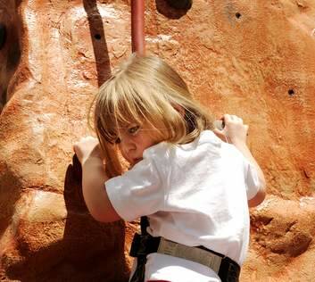 Emily Harcher, 3, on the rock climbing wall that has been set up in Garema Place. Photo: Colleen Petch