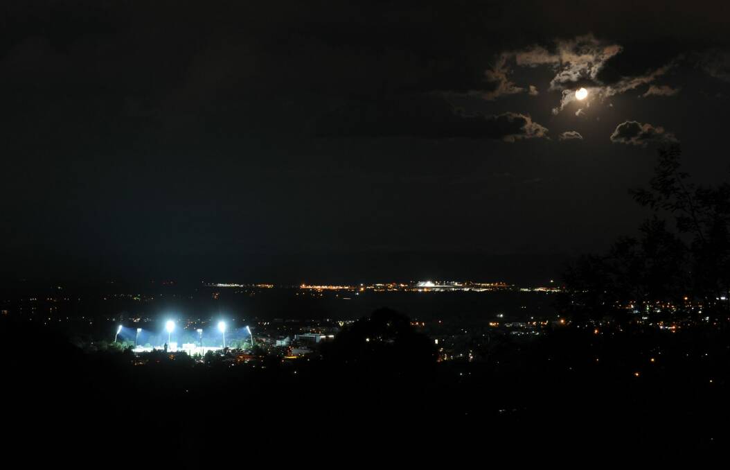 Manuka Oval lit up for the first day/night Prime minister's XI match against the West Indies in 2013. Photo: Graham Tidy