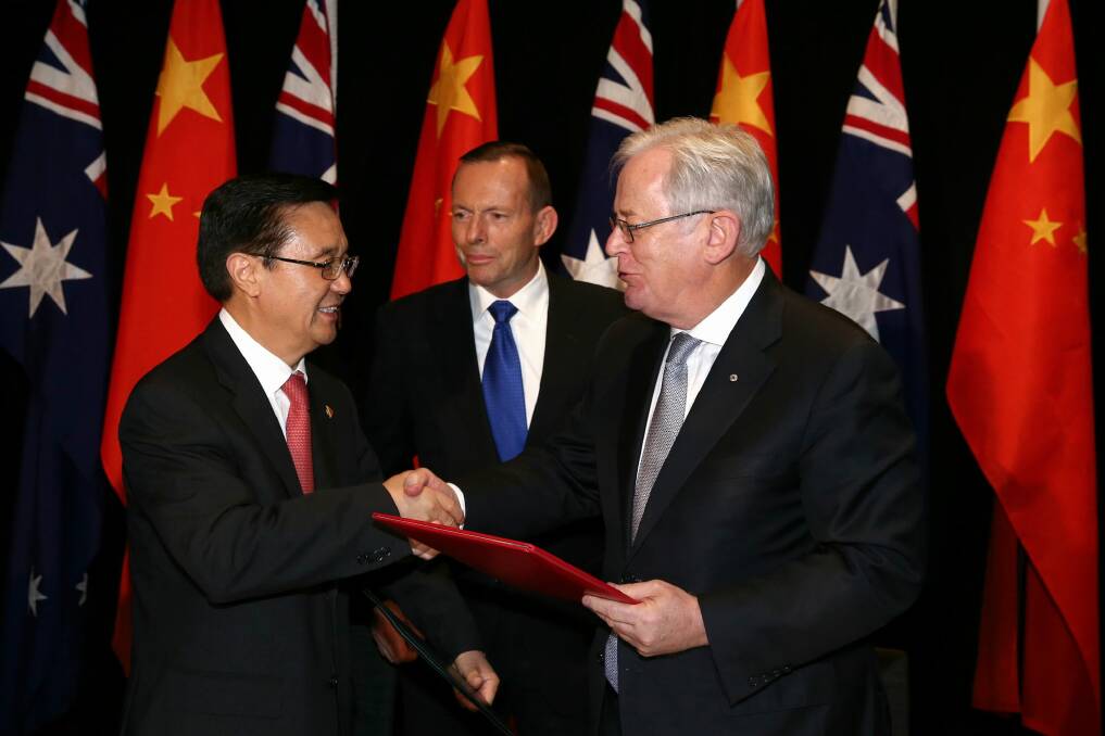Chinese Commerce Minister Gao Hucheng, former prime minister Tony Abbott and then trade minister Andrew Robb at the signing of the China-Australia free trade agreement in June 2015.  Photo: Alex Ellinghausen