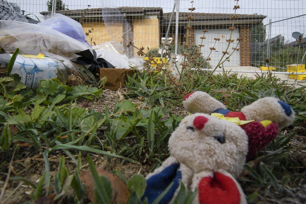 Flowers and toys were left outside the Bonner house fire that claimed the lives of Anne Muhoro and her two children. Photo: Sitthixay Ditthavong