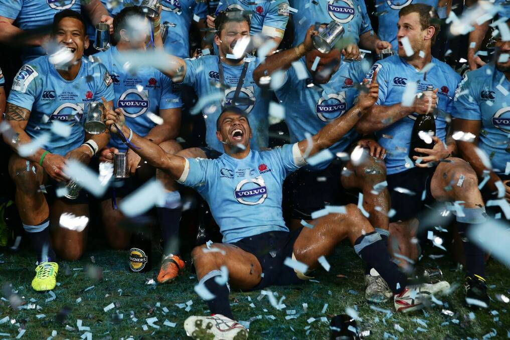 Happy days: Kurtley Beale celebrates with his Waratahs teammates after their 2014 Super Rugby championship win. Photo: Getty Images