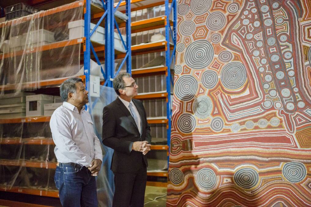 National Museum council member, and Indigenous advisory committee chairman, Peter Yu and National Museum director Mathew Trinca with 'Yumari' by Uta Uta Tjangala. The canvas will be sent to London for an exhibition at the British Museum in April.  Photo: Jamila Toderas