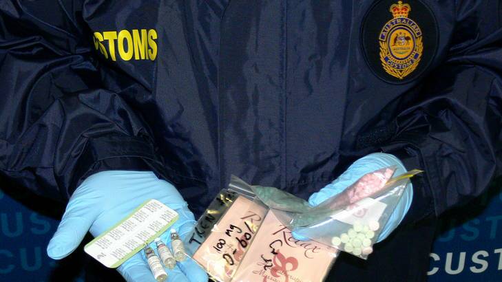 A supplied photo of Customs officers displaying some items seized.