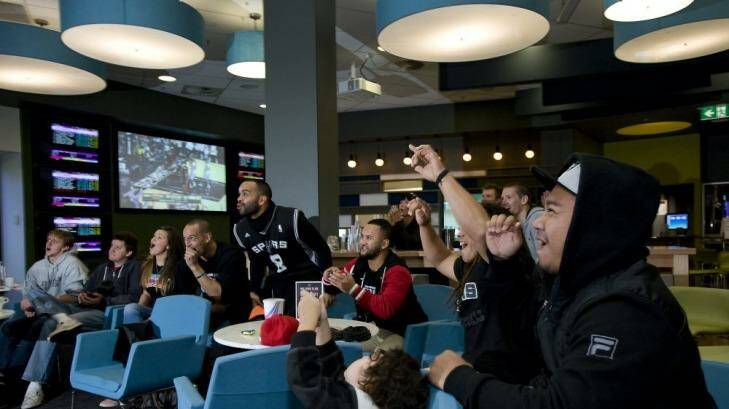 Fans: Patrick Mills' family and friends cheer him on while watching here in Canberra. Photo: Elesa Kurtz