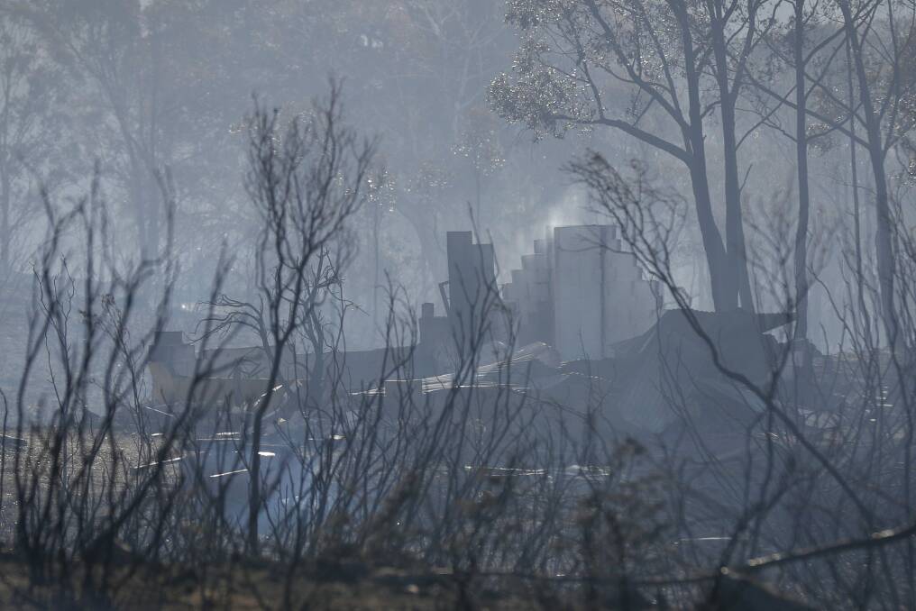 Smouldering remains of a property after a fire at Carwoola. Photo: Alex Ellinghausen