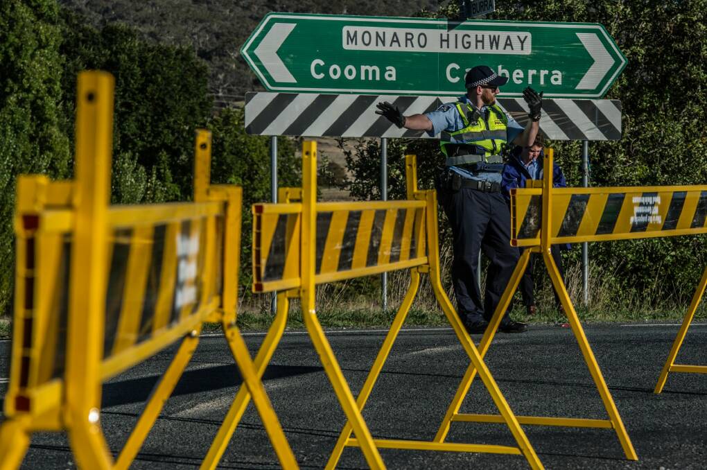 ACT Police conduct road traffic management near the scene of the fatal accident involving a cyclist and a car on the Monaro Highway. Photo: Karleen Minney