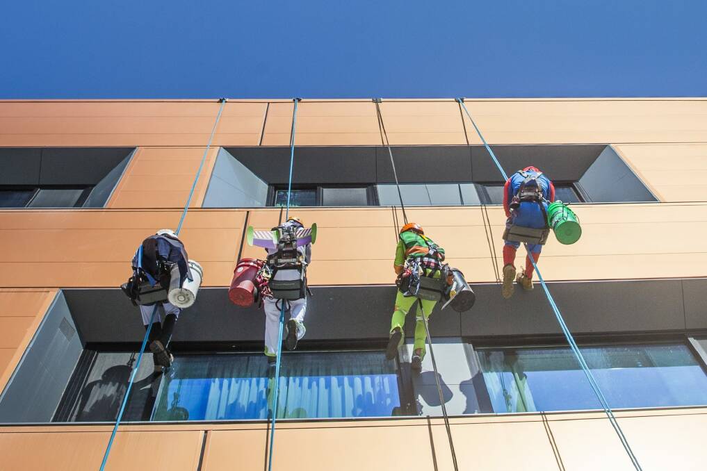 Rope Access Engineering employees dress up to entertain the children at Canberra Hospital. Photo: Matt Bedford