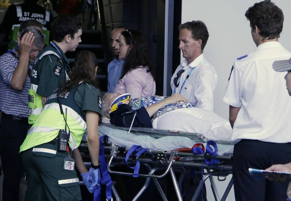The injured woman is taken away by paramedics. Photo: AP